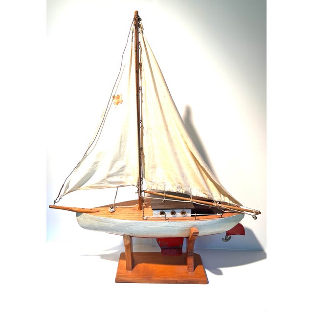 Vintage wooden boat perfect for a nautical themed room. This model sailboat shows its age but it still has so much charm....