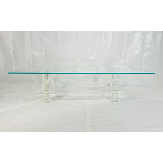 A striking vintage Lucite coffee table attributed to Les Prismatiques, known for their bold architectural acrylic...