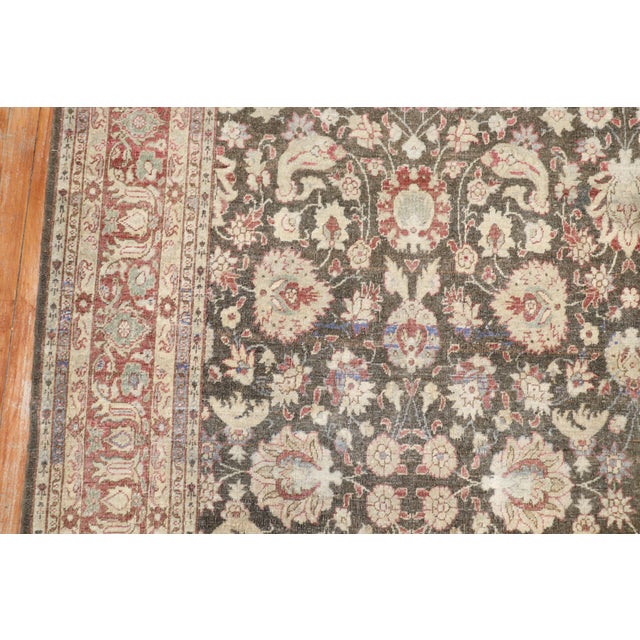 A mid 20th century Turkish Sivas floral pattern rug with a floral field in earth tones Measures: 7'4'' x 10'5''.