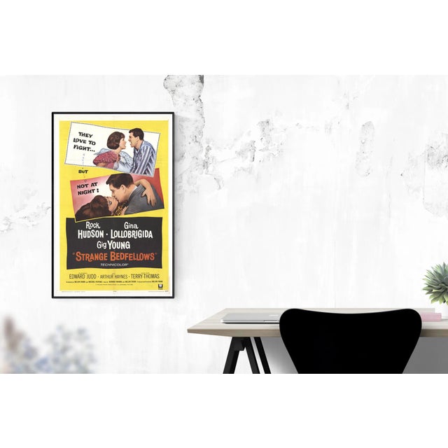 The poster for Strange Bedfellows (1965), starring Rock Hudson and Gina Lollobrigida, highlights the film’s playful tone...