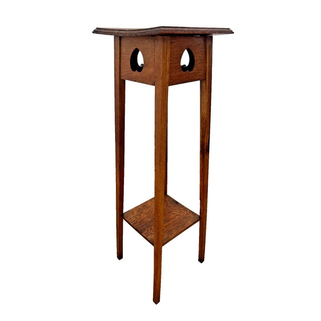 Bring timeless warmth and historic charm into your home with this stunning antique quarter-sawn oak plant stand. Dating...