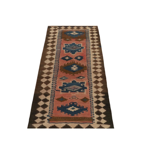 Handwoven in wool from Turkey circa 1950-1960, a unique mid-century kilim rug now joining our vintage flat weaves. The...