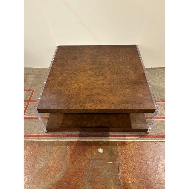 Stylish Revelation Apparition Cocktail Table. Dark burlwood, acrylic sides, gold accents. Original Retail $3795. Showroom...