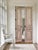 This solid-wood French Country raised-panel barn door features clean architectural lines paired with a single hand-carved...