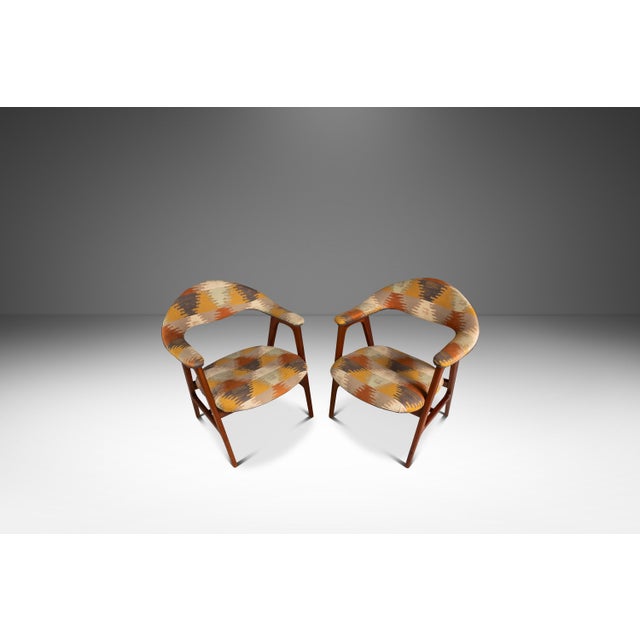This handsome pair of teak armchairs, attributed to Erik Kirkegaard for Høng Stolefabrik, captures the warm, organic...