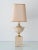 Elegant travertine and brass table lamp attributed to Philippe Barbier, produced in Italy during the 1970s. The design...
