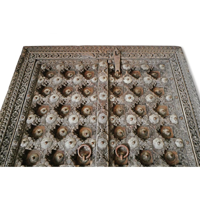 Beautiful antique wood and metal work door from India. Intricate and ornate hand carved and metal details in the Mogul...