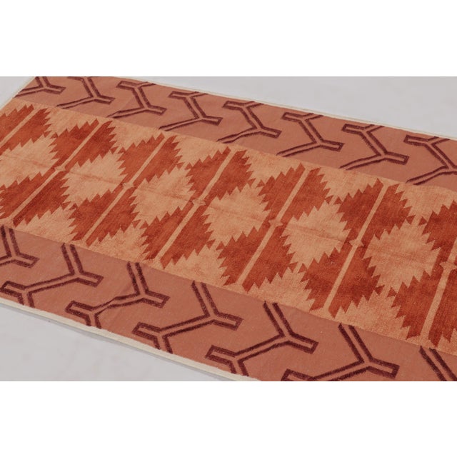 Handwoven in cotton, this 3x5 Dhurrie rug is a vibrant expression of geometric design rooted in traditional flatweave...