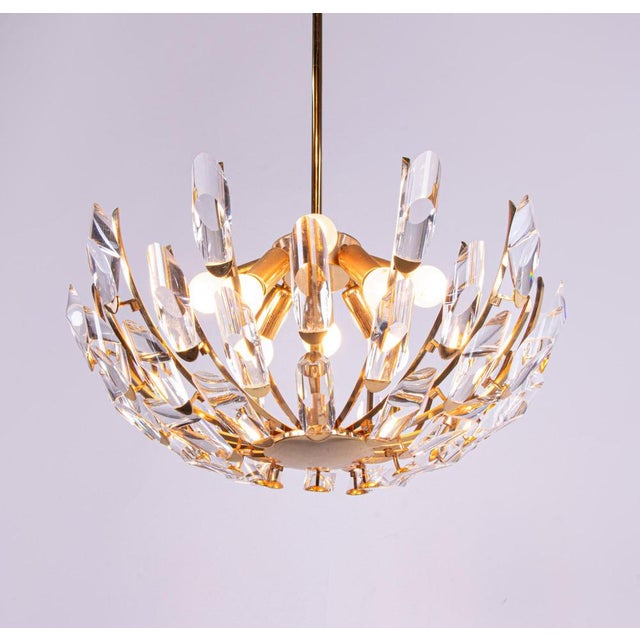 Elegant chandelier with crystal glass on a gold-plated brass frame. Chandelier illuminates beautifully and offers a lot of...
