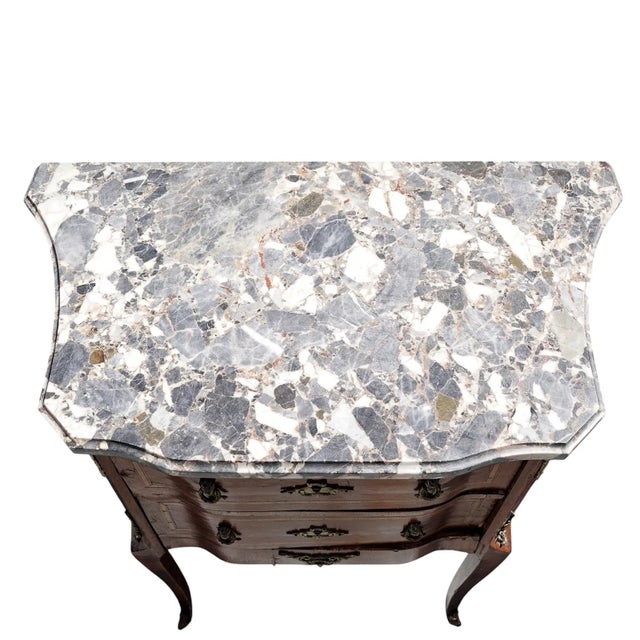 This product is a pair of antique marble top French Louis XV style nightstands. They are fully assembled and have a brown...