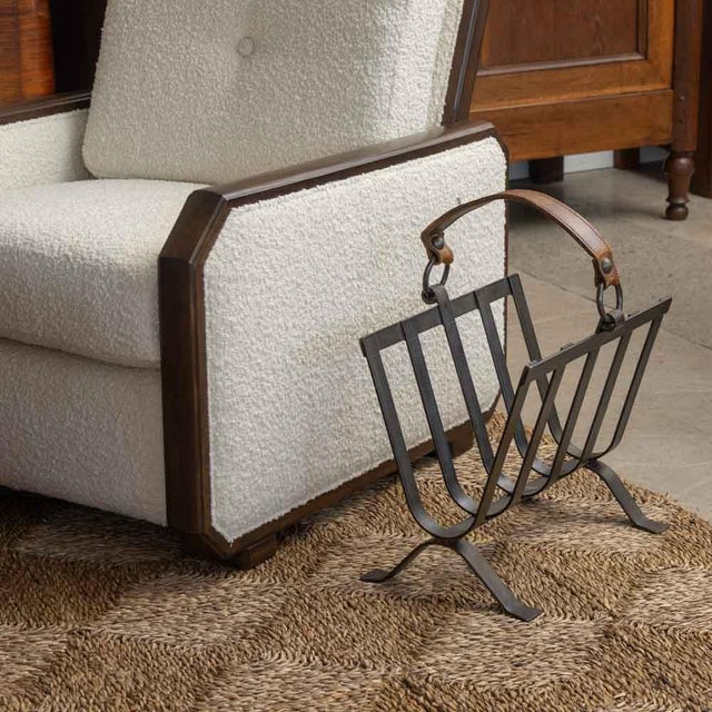 Incredible iron and leather magazine rack from France, 1940s. Original heavy black iron frame with slatted sides and...