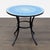 Add a pop of color to your space with this Crate & Barrel round patio table. The vibrant blue mosaic tile top sits on a...