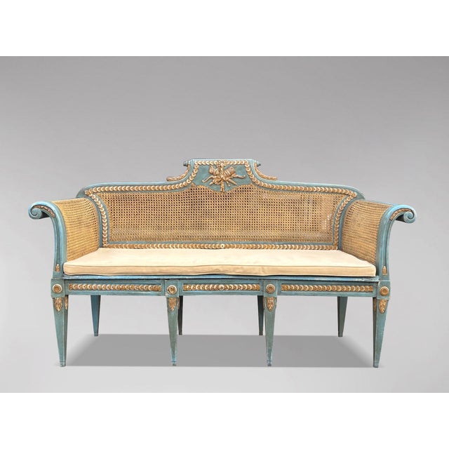 A charming and elegant late 19th-century French painted and caned bench in the Louis XVI taste, retaining its original...