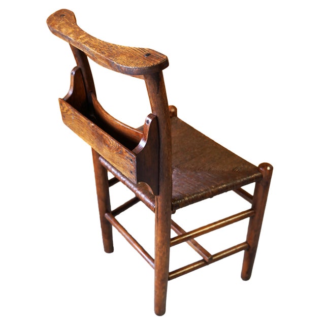 Set of three vintage chapel chairs featuring original hymnal racks and handwoven rush seats. These chairs have a clean,...