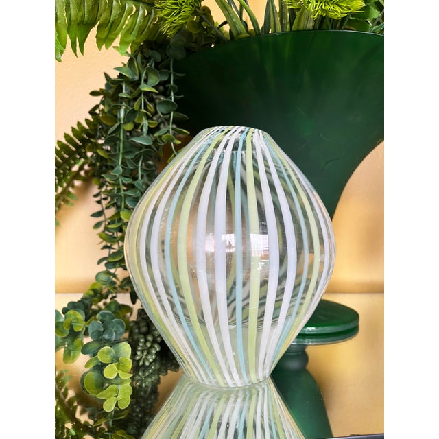 Mid-Century Modern art glass vase in the Murano style with blue and green striped filigree. Made using traditional cane...