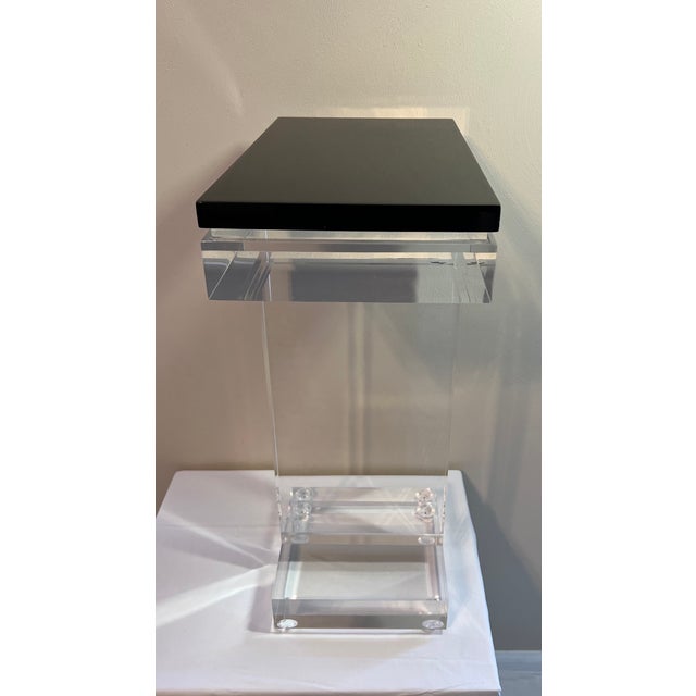 The Allan Knight Concord Occasional Table is an all acrylic design with a 3/4 inch floating wood top in a high gloss wedge...