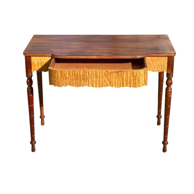 Bay Colony Antiques is proud to offer for sale this wonderful early 20th century Antique Tiger Maple & Mahogany console...