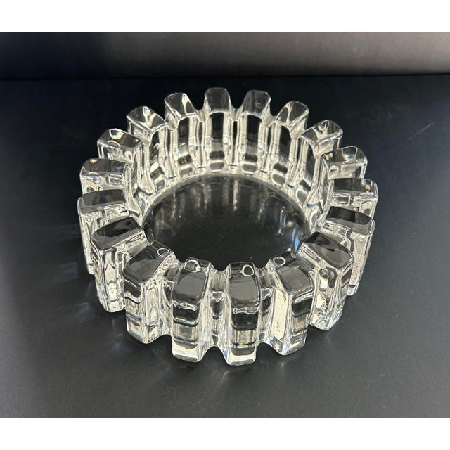 This vintage ashtray has a distinct radial 'spoke' design characteristic of the mid-20th century pressed glass production....