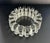 This vintage ashtray has a distinct radial 'spoke' design characteristic of the mid-20th century pressed glass production....