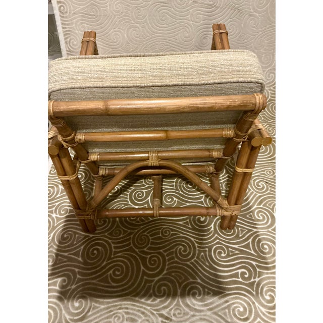 A beautifully constructed vintage rattan lounge chair featuring graceful curved arms, wrapped rattan joints and wonderful...