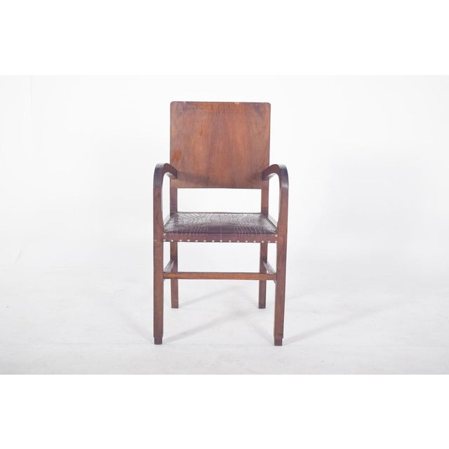 Art Deco armchair. with curved arms and a straight back, representative of the Art Deco style, popular between the 1920s...