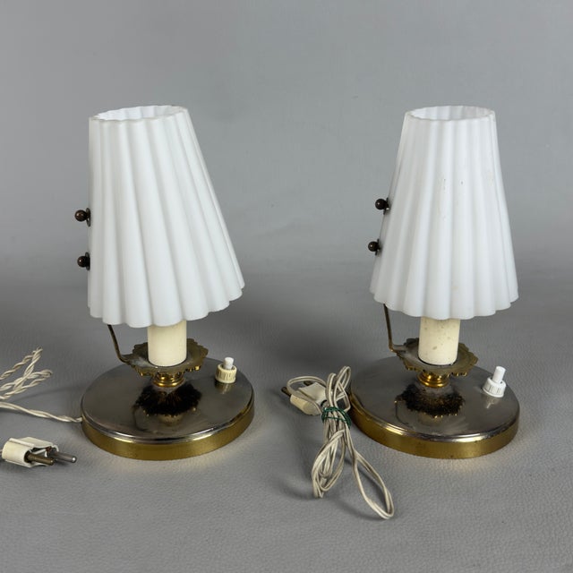 A refined pair of table lamps with a clean, mid-century feel, attributed to Italian manufacture in the 1960s. Design and...