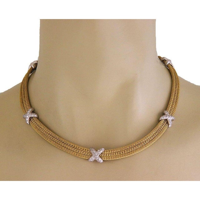 This lovely collar necklace is crafted from 18k yellow gold with white gold accent. It features triple mesh link chain...