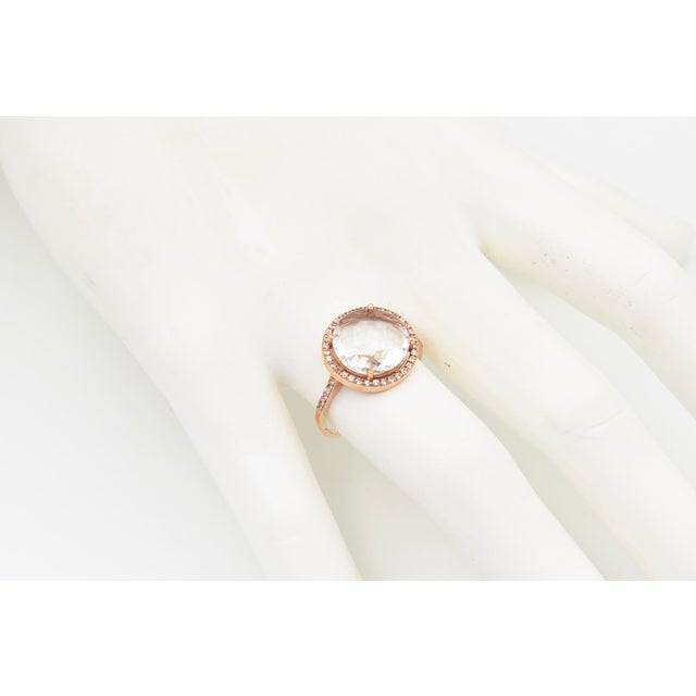Elegant Suzanne Kalan Couture ring crafted in 14K rose gold, featuring a large oval faceted white topaz secured by four...
