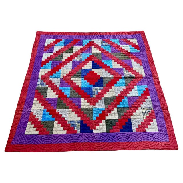 A fine American cotton patchwork quilt with thin batting executed in the Log Cabin primary and Barn Raising secondary...