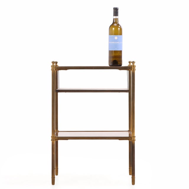 An elegant French three-tier occasional table in the manner of Maison Jansen, crafted with mahogany shelves framed in...