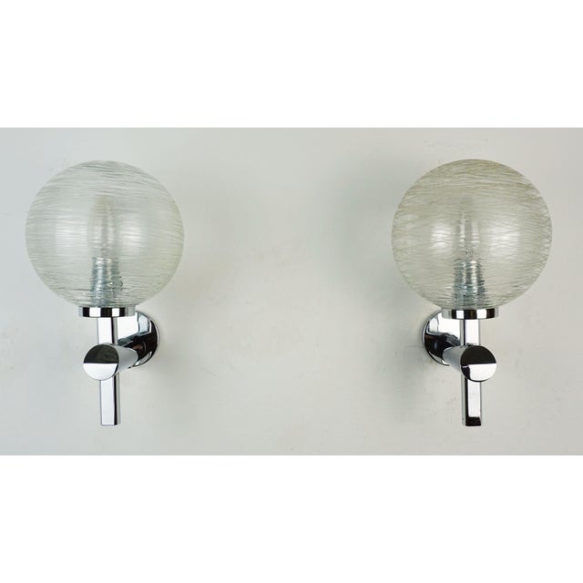 A beautiful and elegant pair of sconces manufactured in the 1970s to 1980s. The base is made of chrome-plated metal with a...