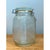 This vintage ribbed glass storage jar is a charming study in utilitarian design, its softly squared, gently tapered body...