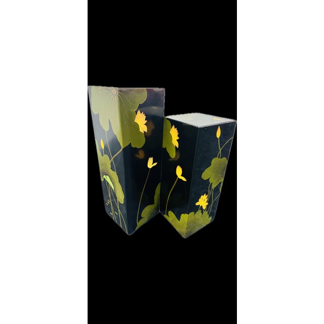 A pair of Asian lacquered pedestals with lily pad motif.Bold color palette with black, green and yellow. Circa 1970s Large...