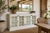 A beautifully scaled 72-inch white painted sideboard featuring four paneled glass doors and a clean, architectural...