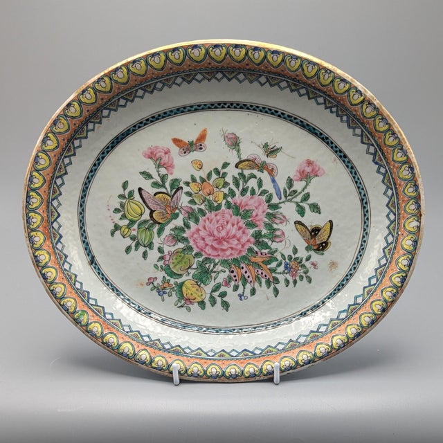 Flowers and Butterflies. Chinese export porcelain platters, circa 1880. The center is bordered with a thin green and navy...