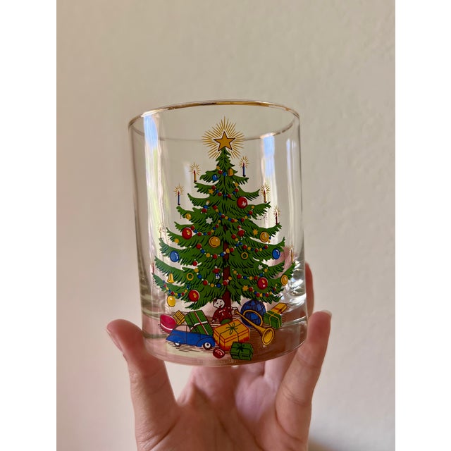 Set of four vintage Christmas tree cocktail glasses from the 1970s featuring beautifully detailed decorated trees with...