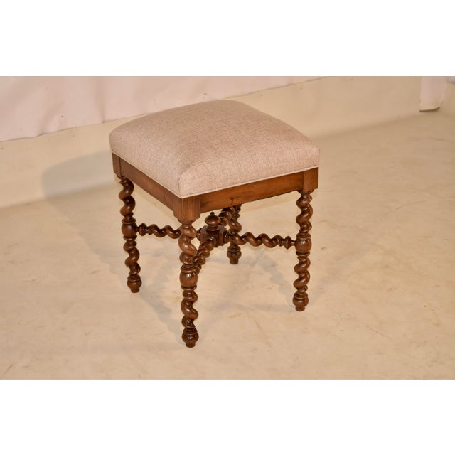 19th century walnut stool from France with newly upholstered seat in linen. This stool is lovely! The seat has Benn newly...