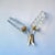 Mid-Century Modern double wall sconce, with sculptural brass arms (spray painted gold), a black rectangular backplate, and...