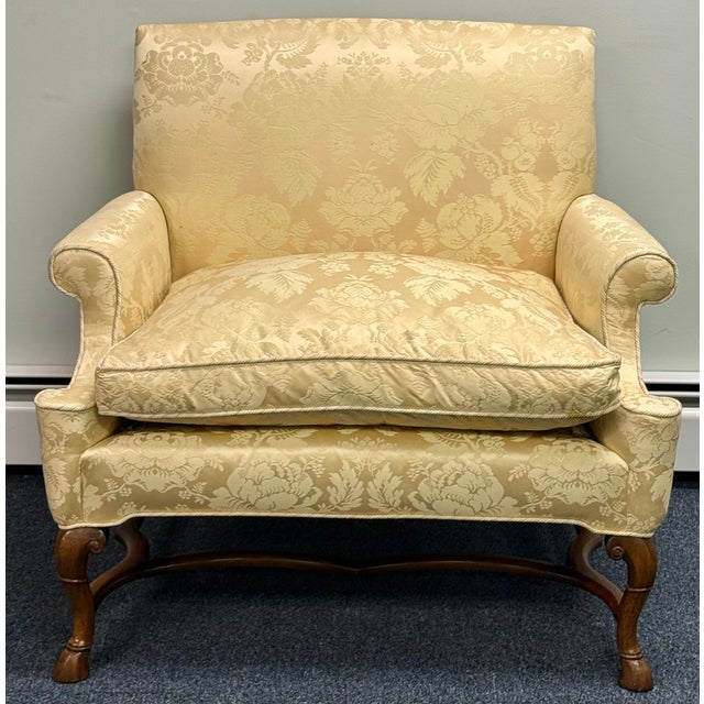 Elegant traditional accent chair upholstered in champagne-gold floral damask with a subtle sheen. Its distinctive shape...