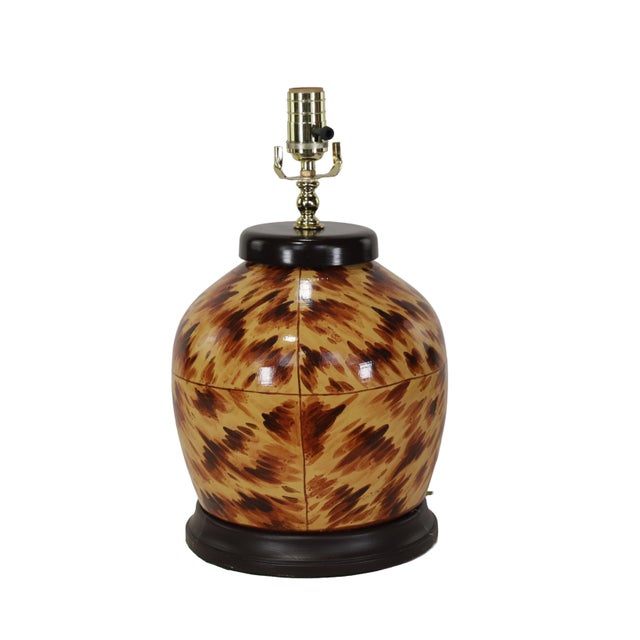 Table Lamps: The iconic tortoiseshell texture showcases swirling patterns of dark brown, caramel, and beige. The lamp body...