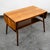 Unique and well made coffee table with a drop leaf design. This table features a figural European walnut grain and a shelf...