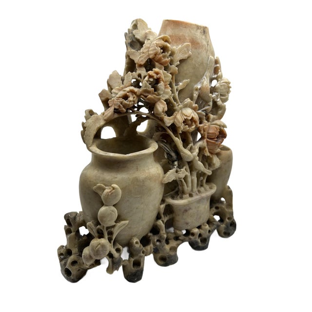 This is an intricate carved Chinese soapstone tableau featuring of elegant vases overflowing with stylized blossoms and...