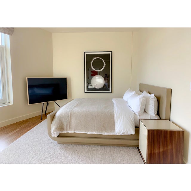 Custom-made Eastern King bed featuring full upholstery in smooth tan leather, including a fully wrapped leather base for a...