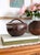 A vintage tenmoku glaze ceramic lidded pot by sought after potter Henry Hammond. Created circa 1960s this rustic mid...