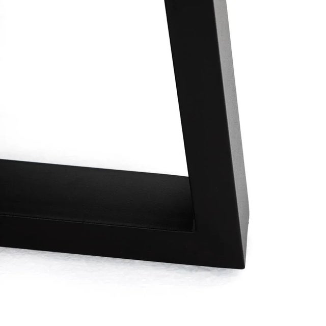 A strikingly simple poly-resin top derived from river sand is polished to a smooth sheen. An angled, matte black iron base...