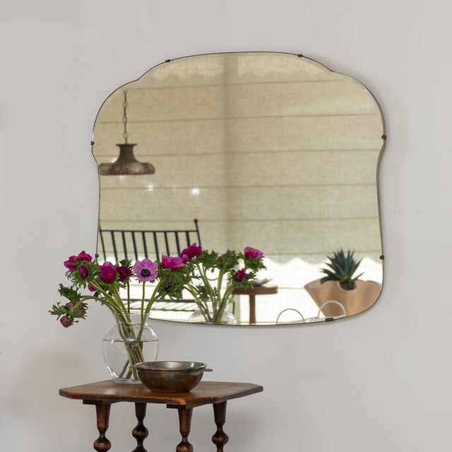 Beautiful vintage mirror from France, 1930s. Lovely wavy beveled mirror secured to a wooden back. Original mirror shows...
