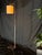 A modern minimalist floor lamp with a clean rectangular frame, square base, and cream fabric drum shade. The frame...