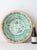 A large hand-painted Spanish ceramic wall bowl from Granada, decorated with the green pomegranate that is the city's own...