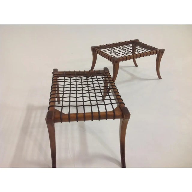 Modern pair of Klismos style ottomans. The ottomans are made of solid walnut with a walnut finish. The ottomans have...