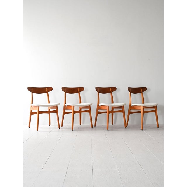 Set of 4 CH-30 model chairs by Hans Wegner with birch wood structure and teak backrest. The seat is padded and lined with...